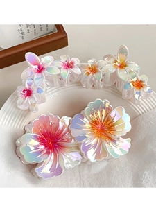 Detail of iridescent flower hair claw clips with translucent gradient petals and pink center