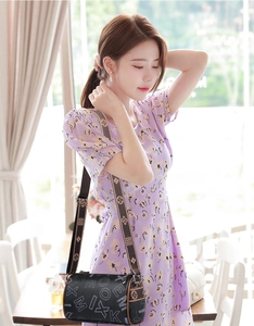 Detail of black cylindrical crossbody bag with MIX MAX ME print and patterned strap