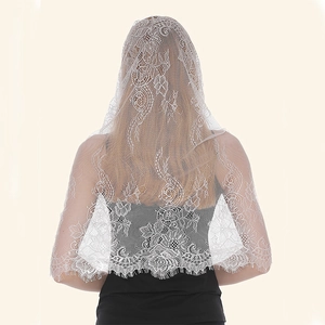 Detail of white floral lace wedding veil with delicate scalloped edges and soft drape