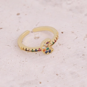 Macro shot of gold moon-shaped adjustable ring with colorful inlaid cubic zirconia stones