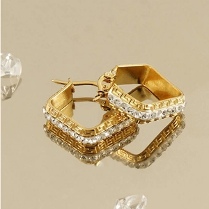 Detail of 18K gold-plated square hoop earrings with Greek fret pattern and clear zircons