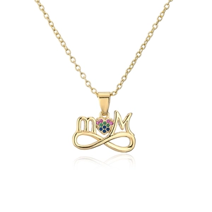 Macro detail of 18K gold-plated MOM pendant with colorful cubic zirconia heart stone