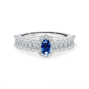 Elegant S925 sterling silver halo ring featuring oval blue sapphire and pavé cubic zirconia