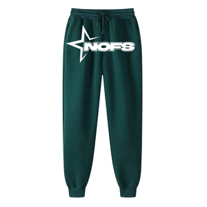 Detail of dark green sweatpants featuring white star print and NOFS logo on the leg