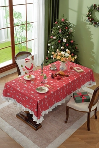 Close-up of red Christmas tablecloth with white deer patterns and ruffle edge details