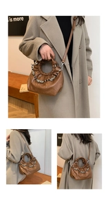 Detail of soft brown pleated cloud bag with stylish beaded chain and metal hardware