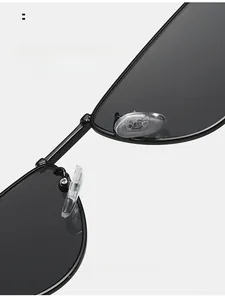 Detail of adjustable silicone nose pads on black metal cat-eye sunglasses for comfort