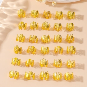Detailed view of 30 golden hollow-out floral pattern hair cuffs for dreadlock braiding