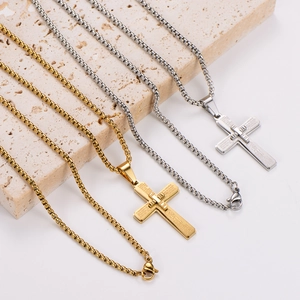 Vintage cross pendant necklaces in gold and silver finish on a textured stone