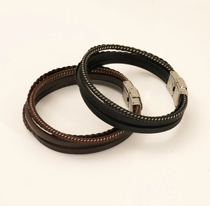 Detail of multi-layer leather bracelets with stainless steel clasps in brown and black