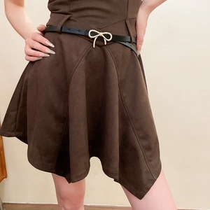 Detail of dark brown suede A-line skirt with black slim belt and golden bow buckle