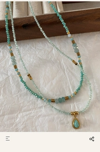 Close-up of double-layer Amazonite beaded necklace with a turquoise teardrop pendant
