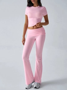 Detail of pink crop top and low-waist flared pants set with fold-over waist design