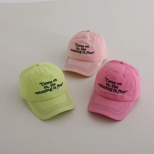 Detailed view of three cotton kids baseball caps in pastel green, light pink and rose pink