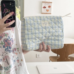 Detail of quilted plaid cosmetic bag in light blue and green with zipper and soft cotton feel