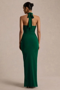 Deep green halter neck dress with backless design and elegant floor-length draping