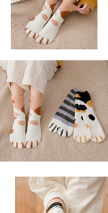 Detail of coral fleece cat paw socks showing thick warm texture and embroidered toe pads