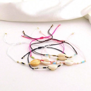 Detail of adjustable bohemian shell bracelets with colorful beads and braided cords