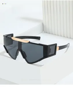 Detail of stylish oversized cycling sunglasses with black frame and gold metal accents
