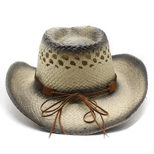 Detail of hollow breathable straw cowboy hat with burnt edge effect and leather cord bow