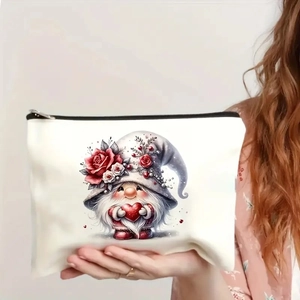 Cream canvas gnome makeup bag with red hearts and rose details, handheld view