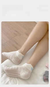 Detail of breathable cotton ankle socks featuring delicate bow embroidery and mesh texture