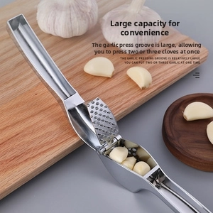Detail of high-capacity garlic press showing large chamber for 2-3 garlic cloves