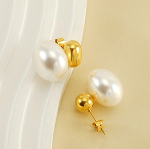 Detailed shot of vintage French pearl earrings with polished gold beads and contrast textures