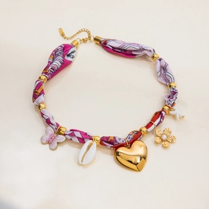 Detail of 18K gold plated necklace with silk-style scarf wrap and mixed charm pendants