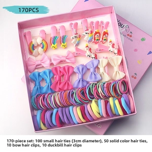 Flat lay of 170-piece kids hair accessories set with bows and clips in a pink gift box