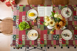 Detail of red and green jacquard Christmas tablecloth with reindeer and heart patterns
