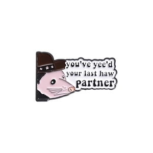 Cartoon opossum enamel pin with cowboy hat and 'you've yee'd your last haw' text