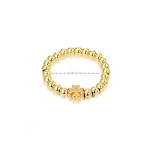 Macro view of gold beaded elastic ring with clover charm showing 2.0g weight and 2cm size
