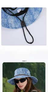 Detail of adjustable thick drawstring and 7.5cm wide brim on blue denim sun bucket hat