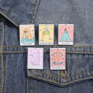 5-piece Tarot style enamel pins with cartoon lyrics on denim jacket pocket