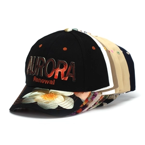 Close-up of letter embroidery and floral print on layered multi-color baseball caps