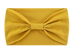 Detail view of yellow knotted headband made from soft ribbed knit fabric for yoga