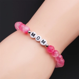 Pink marble bead MOM bracelet with silver spacers for Mother's Day, worn on wrist