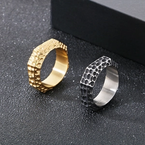 Macro view of wide hammered texture finish on gold and silver stainless steel rings