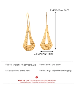 Detail view of hammered gold-tone geometric triangle earrings with dimensions and weight