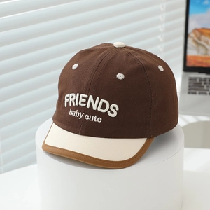 Close-up of the baby baseball cap featuring FRIENDS embroidery and premium cotton texture