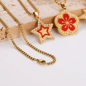 Gold star and flower charm necklaces with red enamel and micro pave crystals on stones