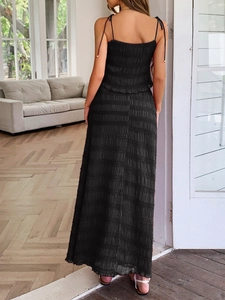 Detail of black camisole top and skirt set showing crinkled fabric texture and back tie-up design