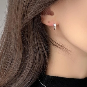 925 Sterling Silver six-prong zircon stud earrings shown on model ear for elegant style