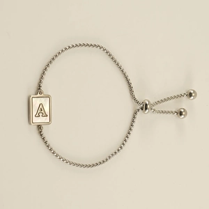 Detail of adjustable silver alphabet A bracelet with white pearl shell inlay pendant