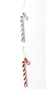 Detail of red and silver Christmas candy cane ornaments with metallic finish on white background