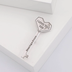 Detailed view of silver heart key brooch with I LOVE YOU and Shasing a dream engraving