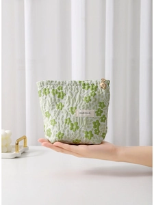 Floral green jacquard makeup bag with gold flower zipper pull and H&R logo label