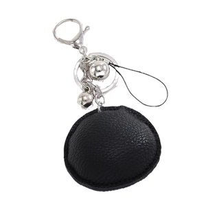 Black leather evil eye keychain with tassel and bell accessory on white background