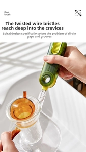 Macro detail of multi-functional gap brush cleaning a glass teapot groove and lid